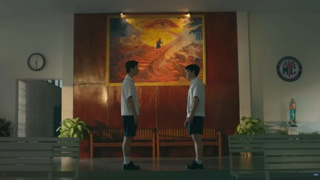Gemini Norawit as Barth and Fourth Nattawat as Tanrak face each other beneath the “Ticket to Heaven” painting in the series.