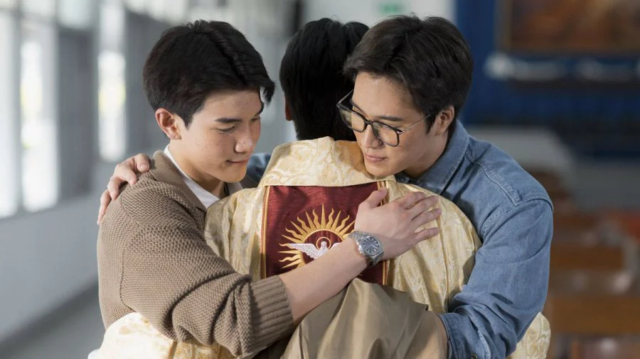 Fourth Nattawat as Tanrak and Gemini Norawit as Barth embrace Father Arnon.