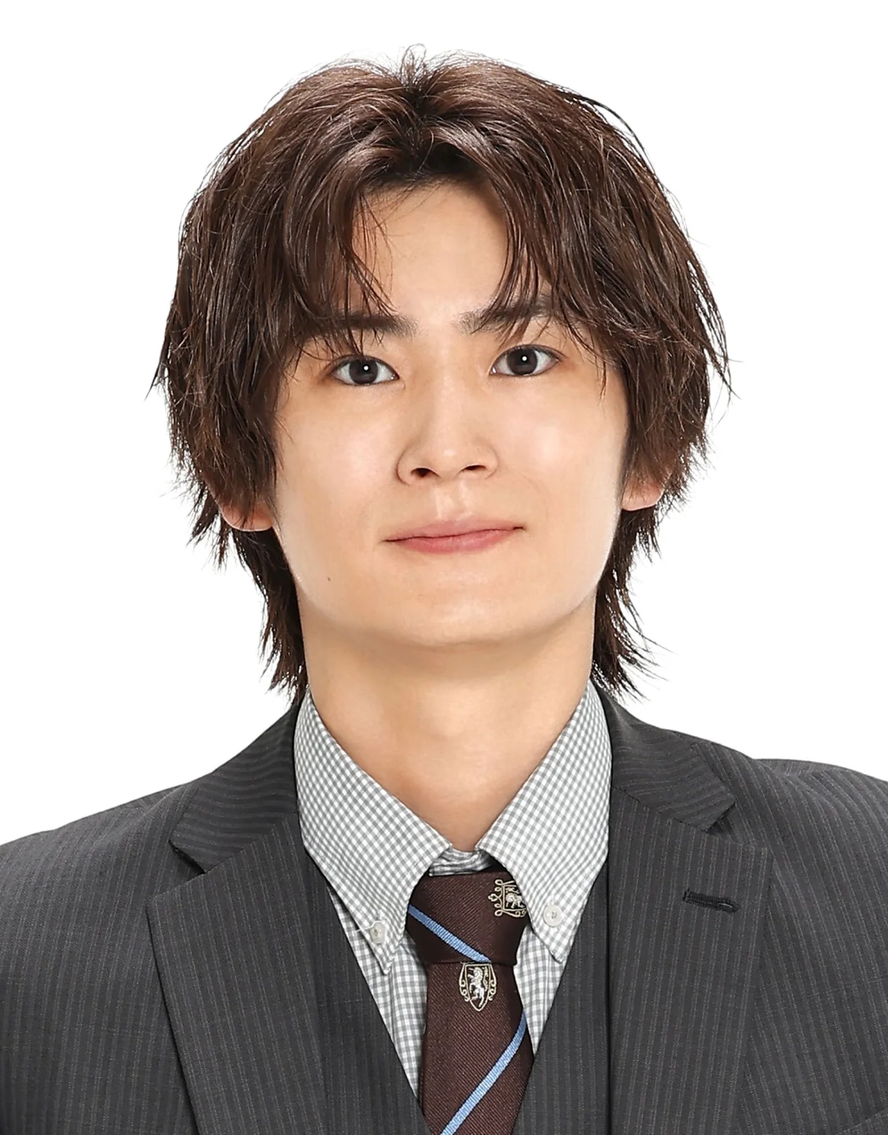 Professional headshot of Japanese actor Gaku Oshida wearing a dark pinstripe suit, checkered shirt and patterned tie against a white background.