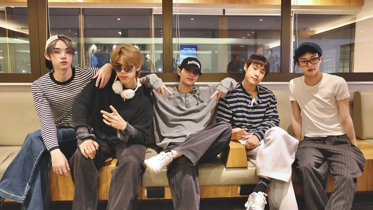 William, Lego, Nut, Hong and Tui of LYKN sit together at an airport before traveling to the United States for the Dusk & Dawn World Tour 2026.