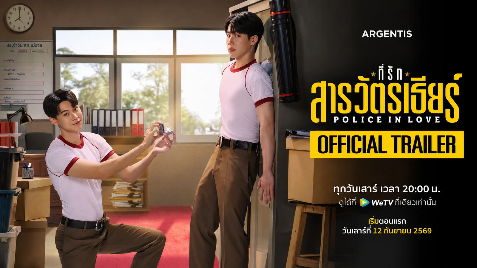 Yin Anan kneels with an open ring box before War Wanarat in a police-station office for the Police in Love official trailer, premiering September 12 on WeTV.