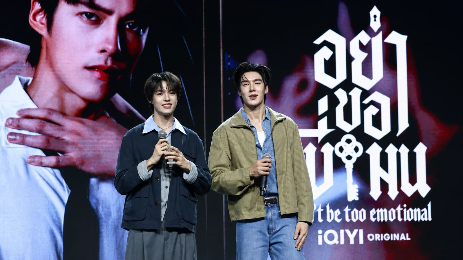 Heng Thatpong, left, and Tee Boonyakait stand with microphones during a Don’t Be Too Emotional event.